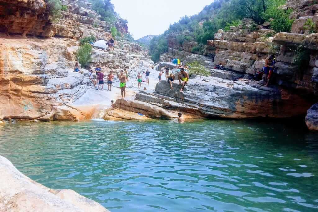 People Enjoying Turquoise Waters in Paradise Valley - Serene atmosphere and crystal-clear pools amidst stunning natural surroundings