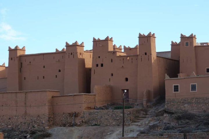 Fortified adobe residence in N'Kob on elevated ground with stone retaining walls