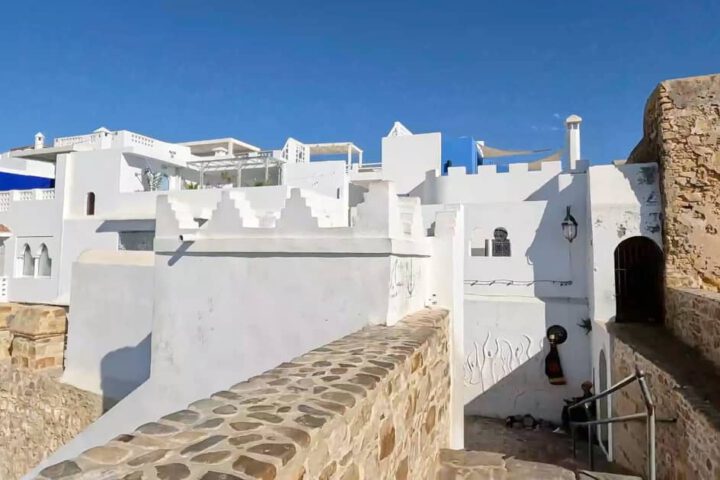 Historic Portuguese ramparts and white-washed houses in the Medina of Asilah on the Atlantic coast of Morocco.