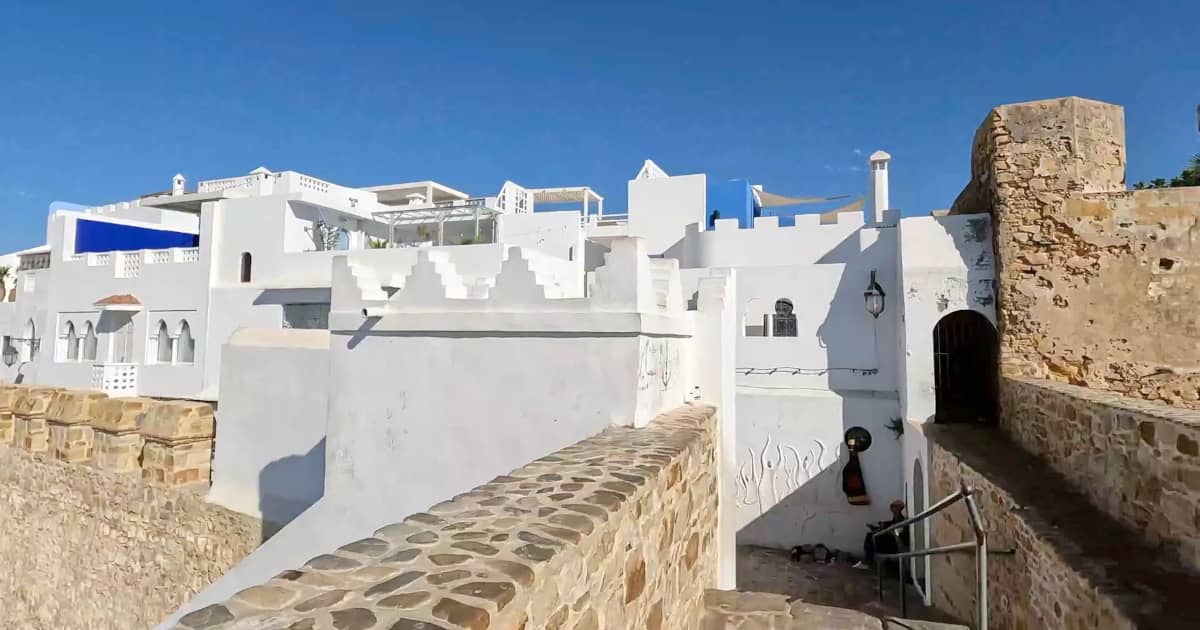 Historic Portuguese ramparts and white-washed houses in the Medina of Asilah on the Atlantic coast of Morocco.