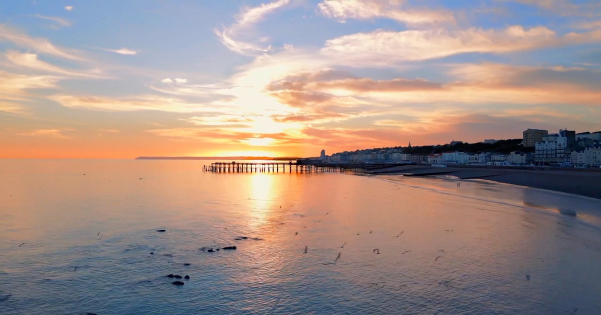 Sunset over the Atlantic Ocean in Asilah, highlighting the town's rich history and art attractions.