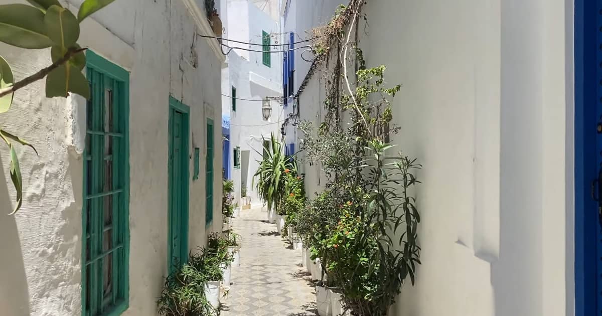 Narrow streets of Asilah’s medina lined with whitewashed buildings.