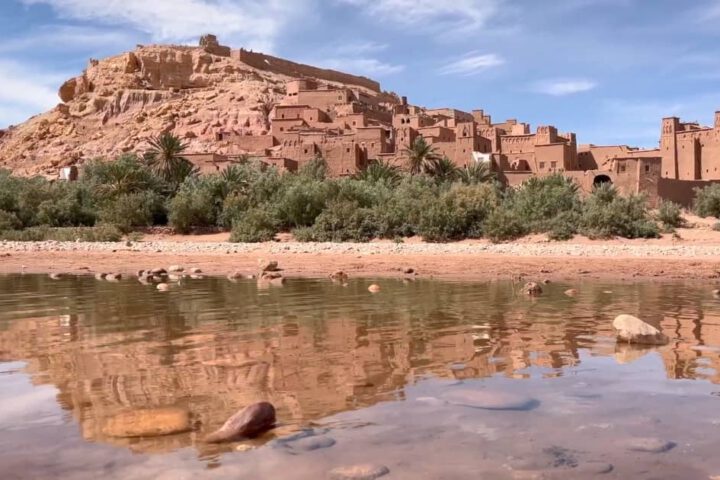 Ancient Kasbah of Ait Benhaddou at sunset with golden mudbrick walls Title: Caption: Walk through the cinematic Kasbah of Ait Benhaddou, where centuries of culture and history blend into Morocco’s red desert landscape.