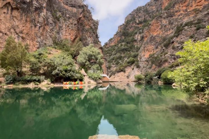 Scenic Akchour waterfall surrounded by lush green forest in the Rif Mountains