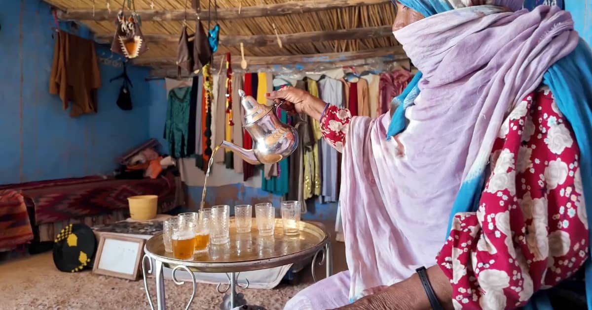 Amazigh Woman Pouring Traditional Mint Tea in Morocco An Amazigh woman pouring traditional Moroccan mint tea in the Atlas Mountains