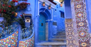 Chefchaouen Street Scene – Morocco’s Serene Blue City Traditional blue medina street with doorways and steps in Chefchaouen