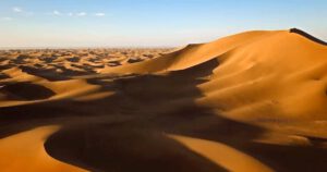 Sahara Desert Trek – Morocco’s Endless Sands Camel caravan trekking across golden dunes of the Sahara Desert