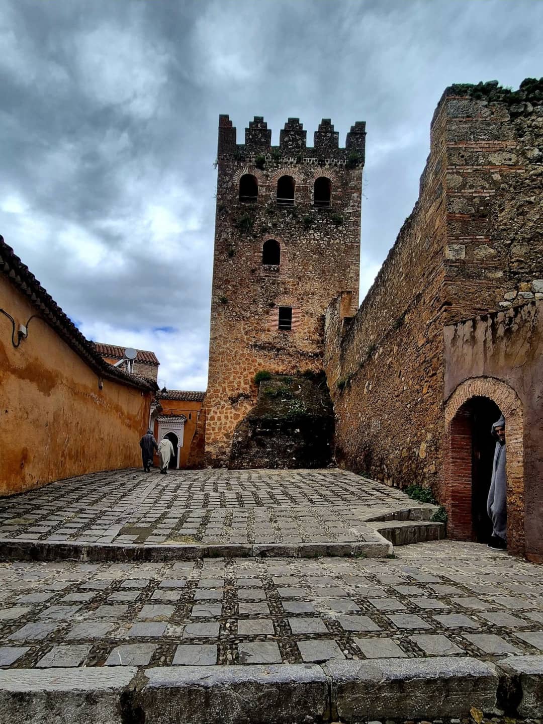 The historic red-walled Kasbah fortress of Chefchaouen surrounded by the iconic blue buildings of the Medina.