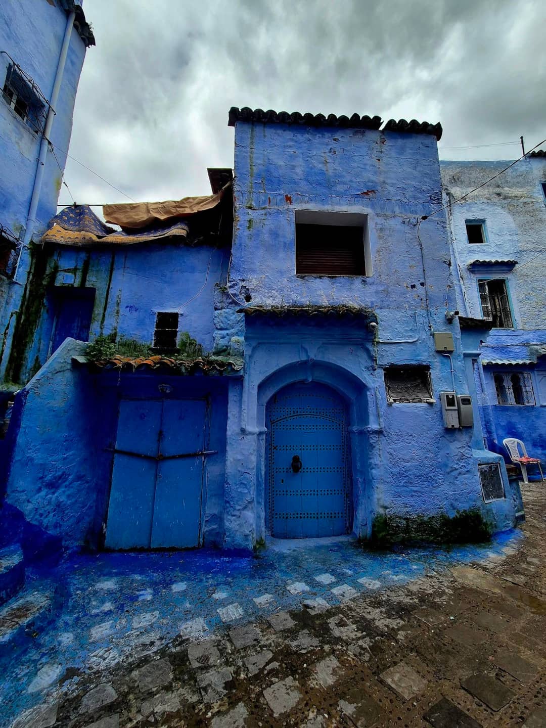 A quiet, alleyway featuring the iconic indigo and cobalt walls of Chefchaouen.