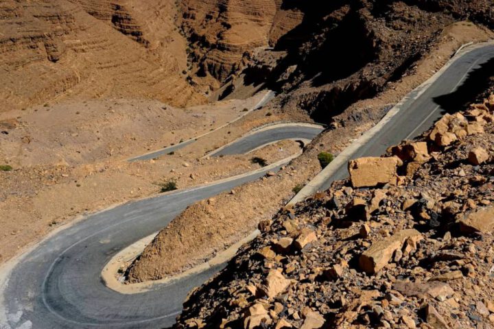 Winding road through the red rock cliffs of the Dades Gorge in Morocco