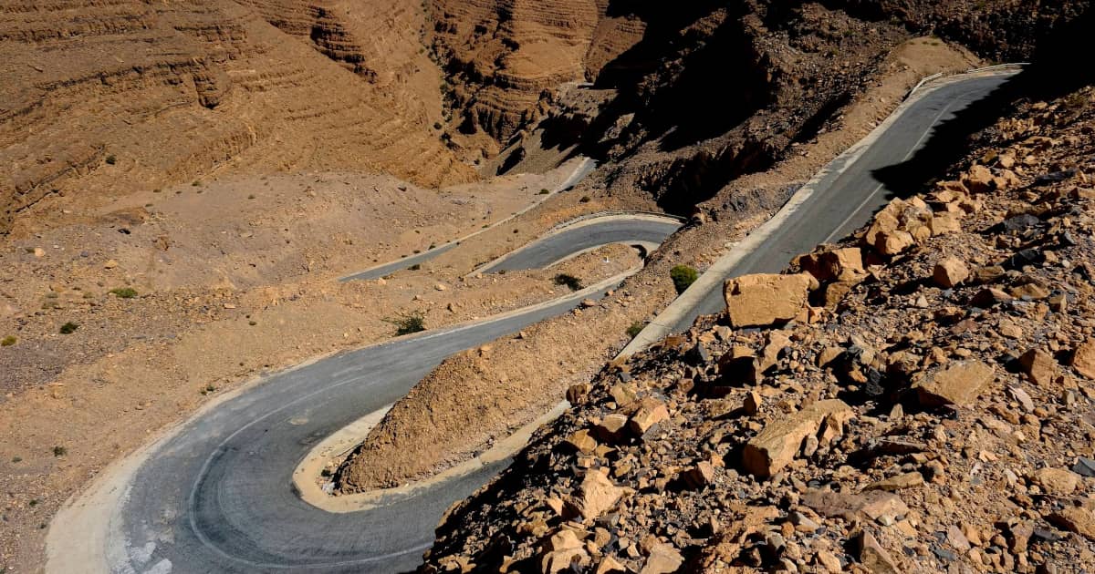 Winding road through the red rock cliffs of the Dades Gorge in Morocco