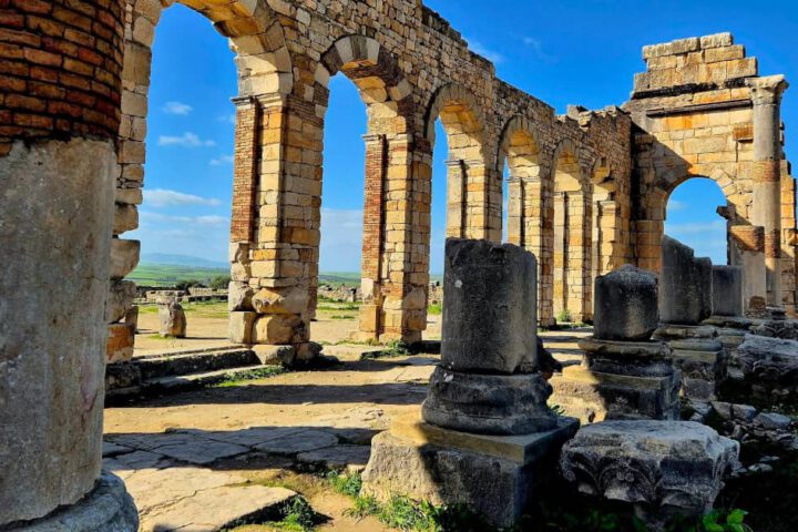 Roman basilica arches and stone columns at Volubilis in Morocco.