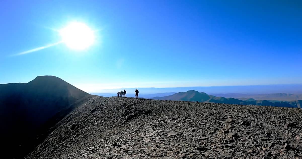 Atlas Mountains trekking Morocco hikers ridge panoramic view
